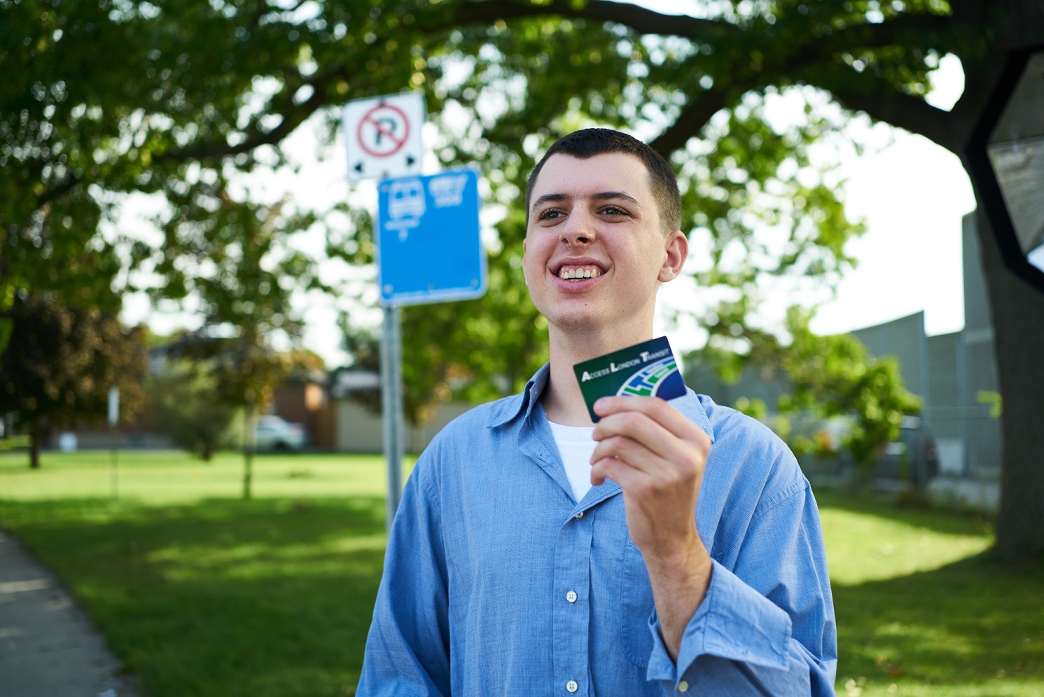 Happy young man waiting for the bus