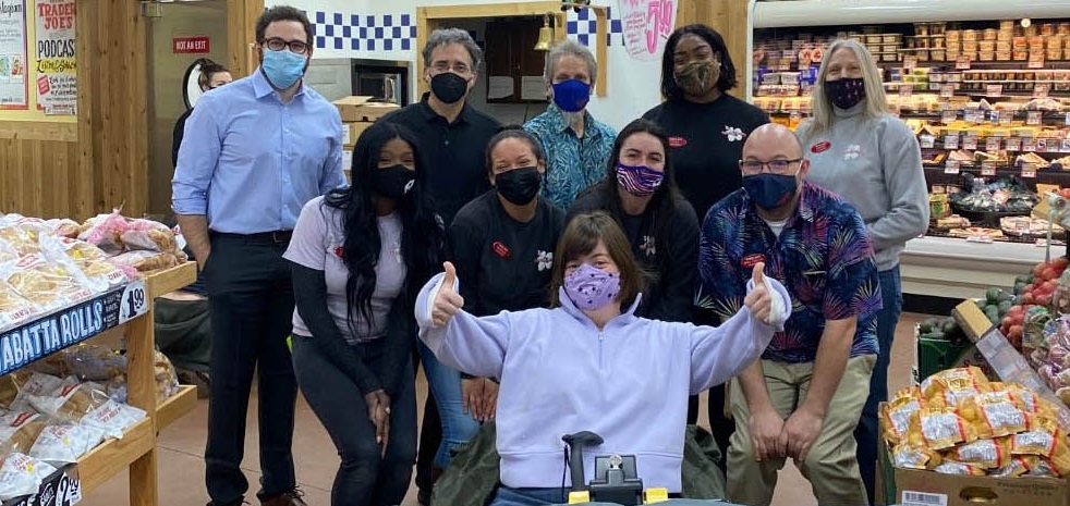 Group of people pose for photo at Trader Joe's grocery store