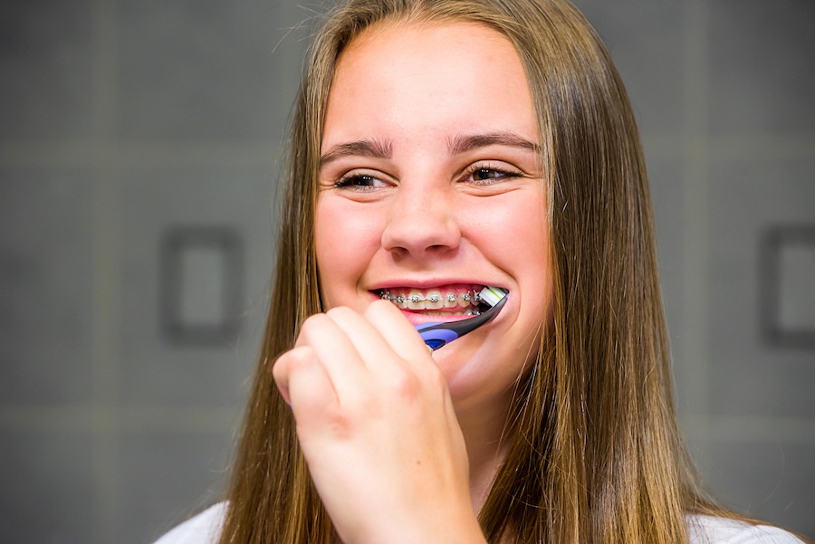 Teen brushing her teeth